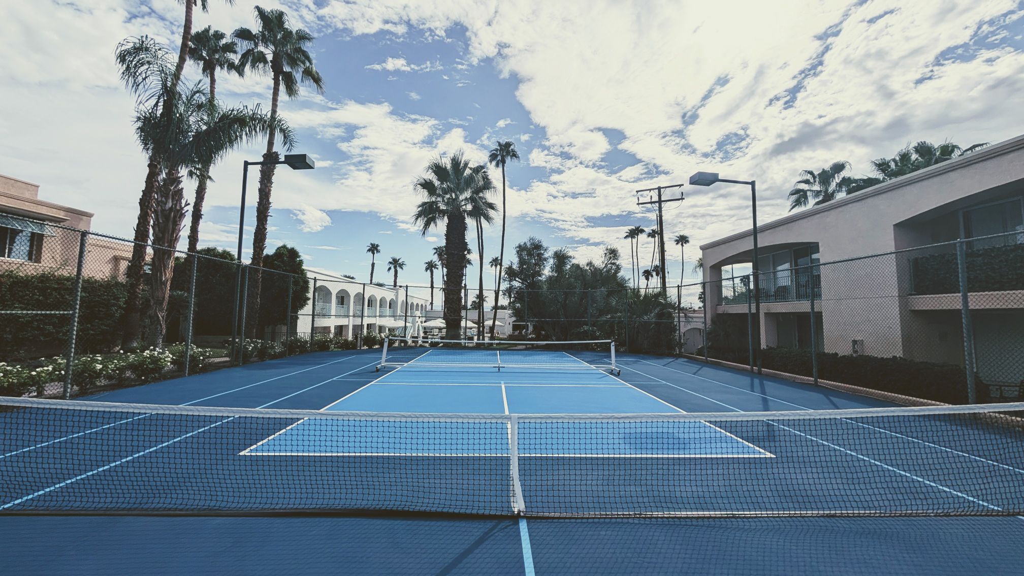 Blue tennis and pickleball courts at Palm Springs, CA resort