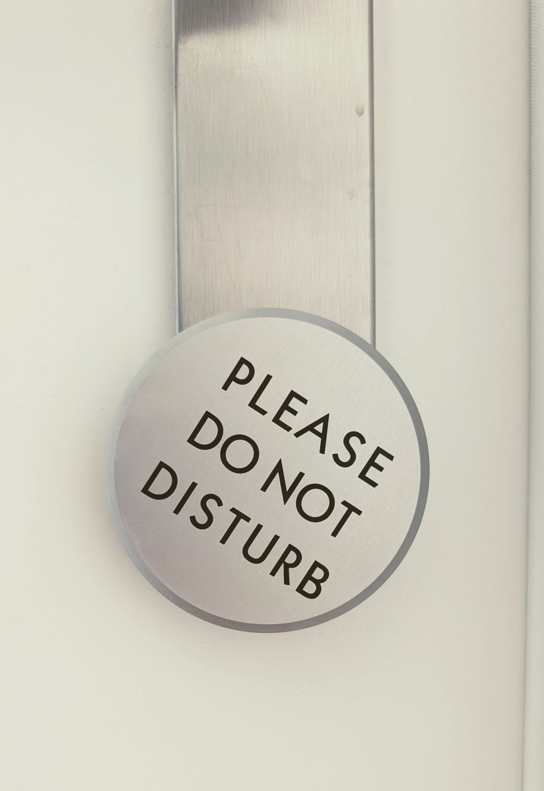 Round silver Please Do Not Disturb sign