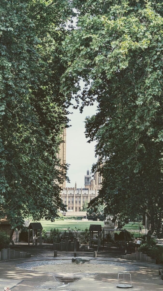 View through trees in London to represent travel poetry 