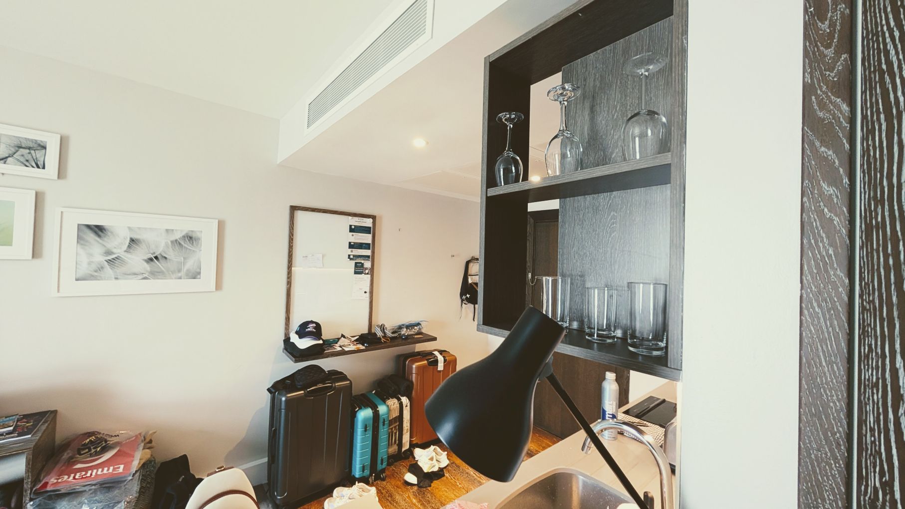 Luggage and dishes in the Staybridge London Vauxhall kitchen area