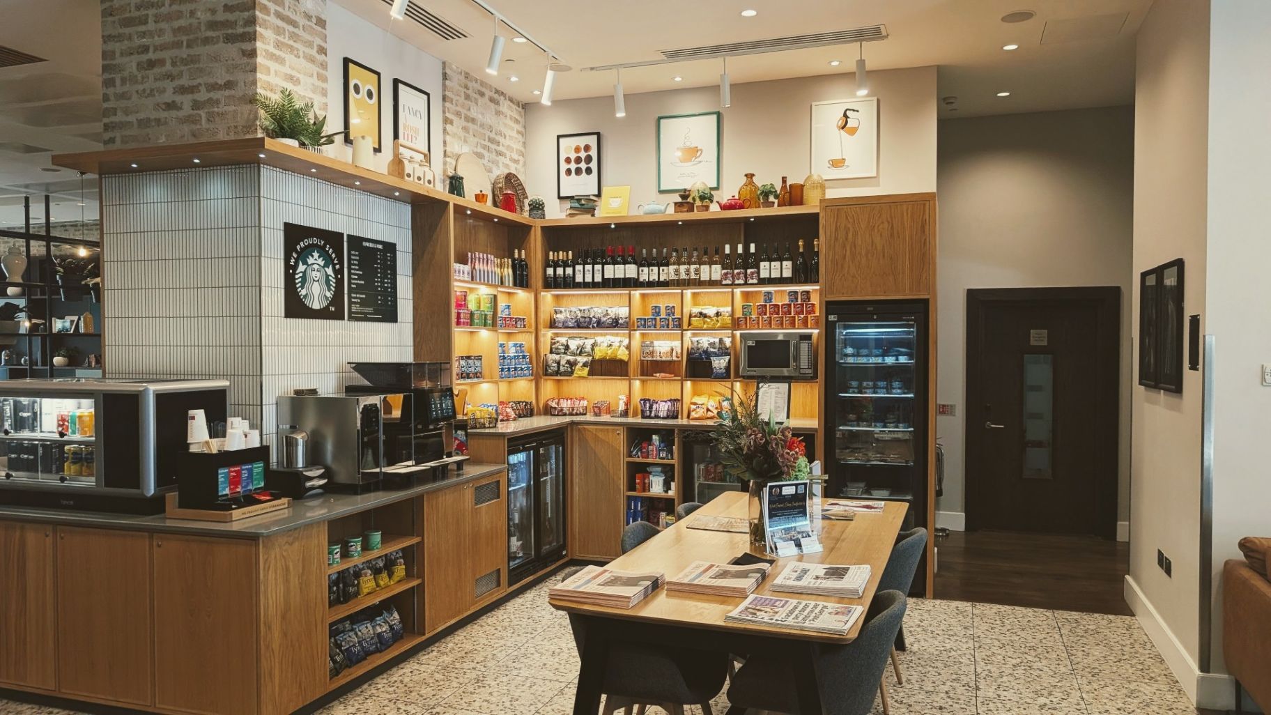 The Pantry hotel store stocked with papers, coffee, wine, and more goods at Staybridge Suites London Vauxhall